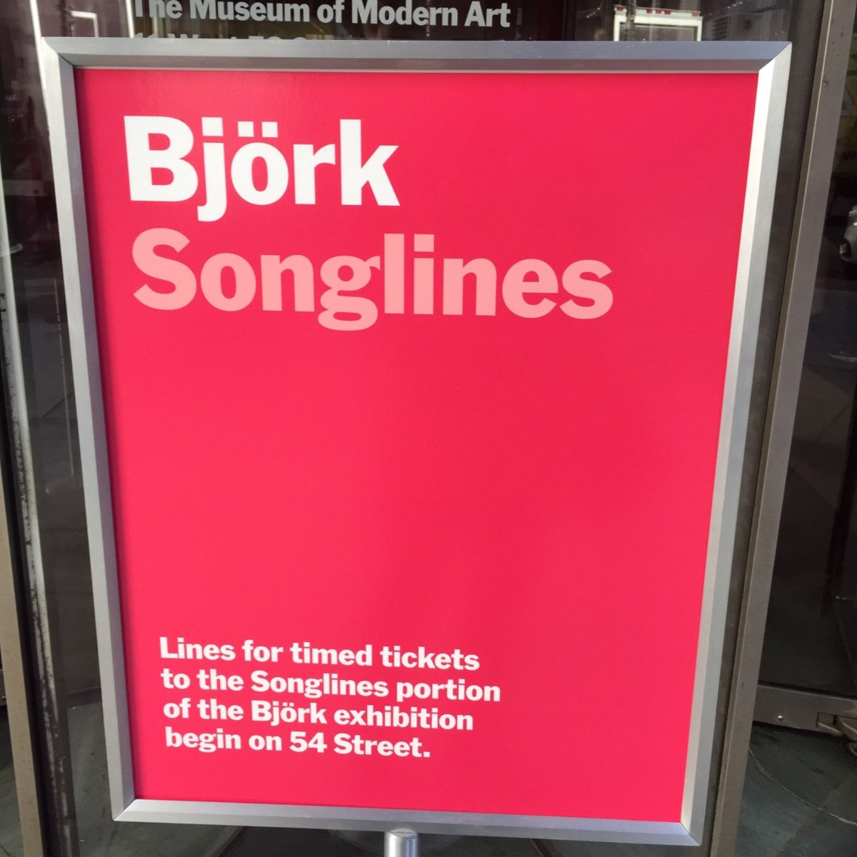 MoMA Björk Songlines signage in the artist's handwritten script on a magenta wall.